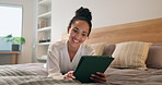 Happy, woman and relax with tablet in hotel bed for holiday, social media or online streaming. Female person, travel or smile with technology in bedroom for vacation, weekend or network in resort