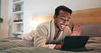 Wave, bed and happy man with tablet for video call, checkin discussion or hello in hotel room. Male person, travel or talking with smile or technology for communication or virtual chat in resort