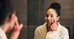 Mirror, happy woman and cream in bathroom for skincare, grooming and skin health on morning routine. Reflection, home and person apply lotion for facial cosmetics, beauty or dermatology benefits