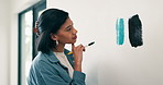 Brush, painting and thinking with woman in house for diy project or renovation decision. Choice, color and comparing with person in apartment for home improvement, makeover change or upgrade