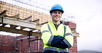 Face, builder and confident man at construction site, development and building infrastructure. Happy person, helmet and civil engineer outdoor for engineering safety, arms crossed and career pride