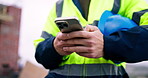 Man, cellphone and hands of construction worker on site with texting, communication or email for feedback. Technology, typing and male civil engineer with phone for chatting with building approval.