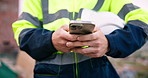Texting, cellphone and hands of construction worker on site with chatting, communication or email. Technology, man and civil engineer with phone for typing on app with contact for building approval.