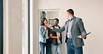 Realtor, walk and consulting with couple at new house, tour or property viewing for real estate. Shock, people or consultant with tablet for inspection, home showcase and client guidance for purchase