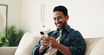 Laugh, texting and man on couch with phone, online communication and comic post on social media. Happy, space and Asian person in house with tech, funny message and meme reaction on chat app.