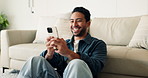 Laugh, text message or man in house with phone, online communication and comic post on social media. Happy, digital or Asian person in home with tech, funny conversation and meme reaction on chat app