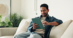 Smile, man and relax at house with tablet, social media and streaming movies for weekend break. Happy, male person and digital in home for research, download ebook and watching comedy video in lounge