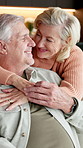Happy, old couple and hug in home with love, soulmate connection or bonding together for retirement. Married senior people, smile and embrace on sofa with care, wellness or affection for relationship