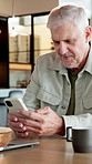 Senior, man and typing in home with phone, thinking and browsing website for retirement planning. Old person, relax and research in house with tech, contemplation and mobile app for life insurance.
