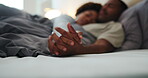 Couple, support and holding hands on bed, home and bonding with partner in bedroom, cuddle and love. Black people, sleeping and resting with spouse in house, affection and commitment for relationship