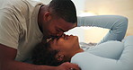 Care, couple and kiss forehead in bedroom with connection, happy and loyalty for love at home. Smile, man and African woman in bed together with romance for support, trust or healthy relationship