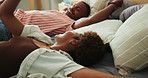 Happy, relax and couple fall on bed with excitement for holiday, break or weekend trip together. Smile, bonding and black man with woman for energy, connection or calm morning in hotel on vacation.