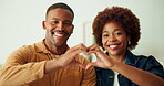 Face, smile and couple with heart in house, commitment and love symbol with partner and anniversary. Black people, home and shape with hand gesture in living room, happy and connection with spouse