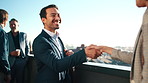 Happy, handshake and meeting with business people on city balcony for partnership, b2b or deal together. Businessman, employees or shaking hands for corporate agreement, introduction in an urban town