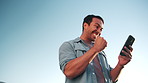 Winning, phone and happy man with fist pump on space for achievement, promotion or good news. Blue sky, excited or male person with smile, app or mobile smartphone for victory, bonus or success