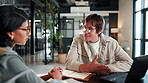 Creative, team and happy people with laptop in office, talking or planning for article with research. Copywriting, online and discussion with colleague, email marketing and collaboration with tech