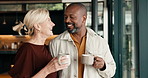 Morning, coffee and mature couple in home with conversation, connection or smile for bonding together. Happy, interracial marriage and people by window with tea, discussion and romantic relationship.