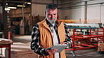 Tablet, man and woodworker in workshop for research on timber inventory for industrial project. Digital technology, email and mature carpenter with feedback on furniture production at warehouse.