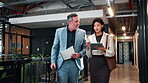 Office, team and walk with tablet, meeting and financial forecasting with report or info on website. Economist, collaboration and people with tech, brainstorming and business strategy with paperwork