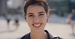 Outdoor, student and face of woman with confidence, academic development and learning for scholarship. Portrait, wind and happy scholar with college education for knowledge, pride and study in city