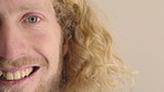 Half, face and man in studio, smile and hair care with dermatology on white background. Happiness, space and person with wellness, healthy scalp and texture with volume,  maintenance and keratin
