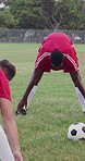 Sports, warm up or team on field with soccer ball, stretching or injury prevention in weekend match. Fitness, start or people with collaboration, muscle preparation or getting ready for football game