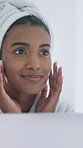 Skincare, mirror or Indian woman in bathroom with check, smooth skin or soft touch in morning routine. Dermatology, happy or person in home with towel, facial care or grooming results in reflection.