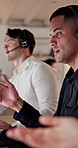 Night, man and talk in office with telemarketing, advice and explain insurance for lead generation. Late, coworking and person in call center with consulting, insight and discussion for policy sales.