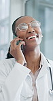 Doctor, phone call and woman with smile in hospital, telehealth and discussion with patient or help. Clinic, medical advice and black person with mobile, healthcare and laughing at joke and chat