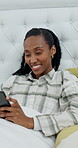 Morning, scroll and black woman in bed with phone, smile or check social media for news on weekend. Happy, female person and relax in house with pajamas, tech and mobile app for reading blog article.