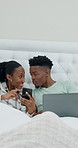 Laptop, phone and black couple relax in bed with credit card, online shopping or social media in home. People, ecommerce and digital tech in bedroom for subscription, purchase or discussion and sale