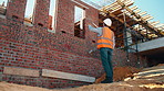 Construction, building or man on site with review, progress or safety check of structure. Compliance, ppe or engineer with assessment, quality analysis or industrial evaluation in project management.
