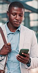 Phone, upset and black man in office with email, communication or texting with investment loss. Technology, bad news and male financial manager on cellphone for negative feedback on finance report.