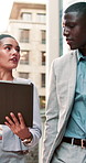Travel, city and business people on tablet and talking for finance proposal planning and update. Corporate, town and woman with man on tech for discussion, feedback and teamwork for financial review