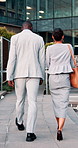 Back, talking and business people in city walking to office for work, proposal update and finance team. Corporate, travel and woman with man in discussion, chat and meeting for feedback in town