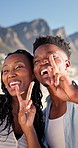 Smile, beach and peace sign with black couple for love, romance and honeymoon or vacation for travel. Holiday, gesture and man with woman for happy, marriage and seaside with relationship and summer