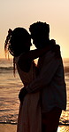Forehead, hug and couple at beach with sunset for bonding on holiday, vacation and weekend. Dating, silhouette and man with woman for embrace, touch and happy for relationship, connection and love