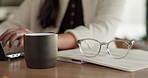 Hands, laptop and typing with remote work from home for schedule, checklist or review with coffee. Person, freelance job and notebook for copywriting career, feedback or reminder with drink at house