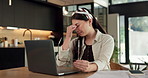 Remote work, headache and woman in kitchen, laptop for online article and deadline. Freelancer, writer or person in home, migraine or blue light exposure with pressure, tension or tired with fatigue