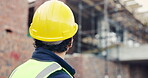 Construction, back and man with building inspection for masonry safety, progress and compliance. Helmet, civil engineer and monitor site development for defect management, quality control and project