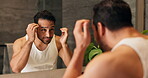 Mirror, man and beard care with wink in bathroom for beauty, grooming or check skin in morning routine. Reflection, home or person with facial hair inspection, cosmetics or skincare for wellness