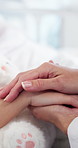 Hands, hospital and doctor with child in bed for comfort, empathy and support for medical recovery. Healthcare, pediatrician and kid with compassion, care and console for wellness, help and healing