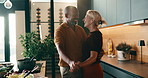 Dancing, cooking and couple in kitchen at house with music for bonding, love and connection. Happy, care and mature man with woman for moving to romantic playlist with preparing meal in home.