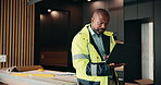 Laptop, renovation and serious with black man in kitchen for home improvement or upgrade project. Computer, real estate and research with mature construction worker in apartment for property update