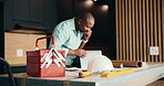 Phone call, renovation and toolbox with black man in kitchen for home improvement or upgrade. Communication, construction and laptop with mature contractor in modern apartment for building project