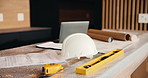 Laptop, helmet and building with construction documents for architecture, maintenance or planning. Empty, hard hat and computer with paperwork or floor layout for PPE safety, security or installation