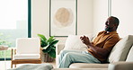 Man, applause and watching tv on couch with sports game, goal celebration and football competition. Mature, black person clap and cheering in home with soccer broadcast, happy and excited for win.