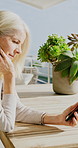 Mature, woman and outdoor at house with phone, scroll or check social media update on weekend break. Person, relax and reading on balcony with digital tech, mobile app or website for online blog post