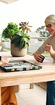 Board games, funny and playing with old women in home together for bonding or reunion. Backgammon, laughing and rolling dice with senior people at table in apartment for activity, fun or retirement