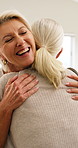 Mature, women and hug in house for visit, bonding and connection in living room with a smile. Friends, people or sisterhood with embrace, care and love with conversation of gratitude for relationship
